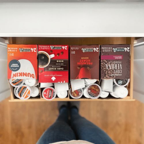 Draw of a cupboard holding four open boxes of Keurig® K-Cup® coffee pods.