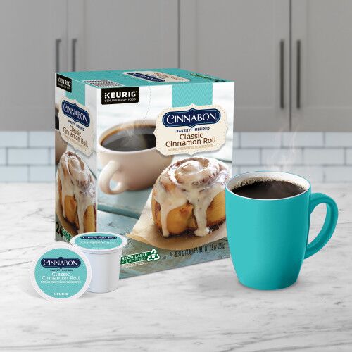 cinnabon kcup coffee pods and mug of coffee on kitchen counter