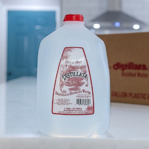 distillata distilled 1 gallon case on counter close up with cardboard case in backgrgound